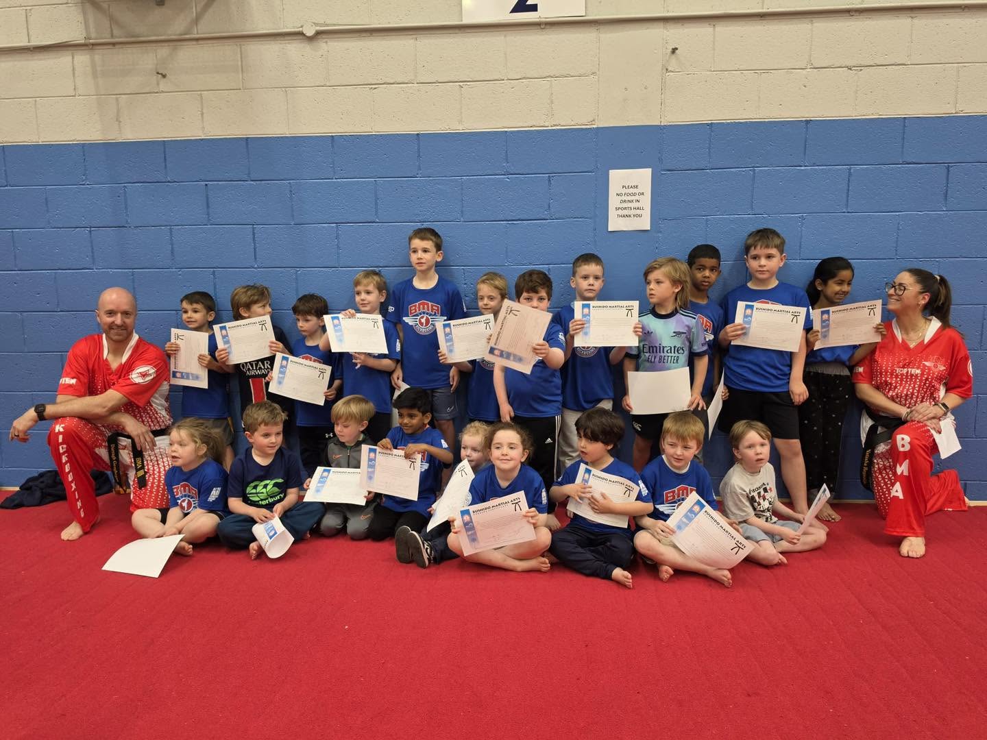 Bushido students and coaches celebrating their grading certificates